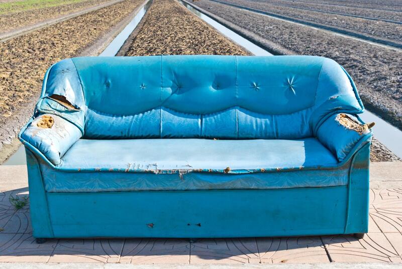 blue damaged and dirty sofa
