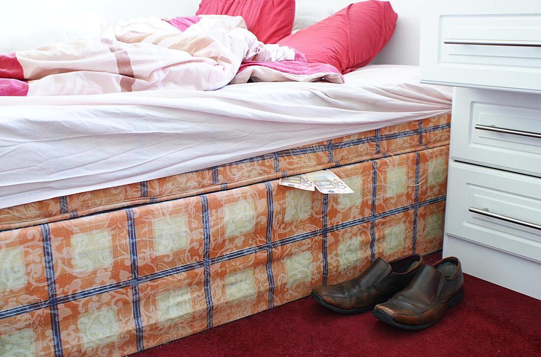 mattress with sheet and old leathered shoes 